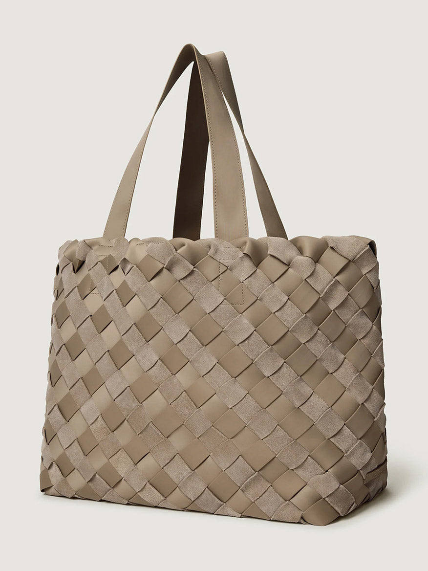 Naghedi Como Medium Tote Suede & Neoprene in Bluff, a taupe handwoven tote with alternating smooth and Italian suede-textured exterior strips and two shoulder straps.
