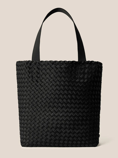 The Naghedi Como Shopper Tote in Onyx, featuring two sturdy handles and shown against a beige backdrop, is a versatile unisex neoprene bag ideal for everyday use.