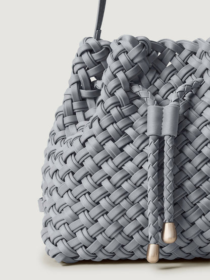 Naghedi Gramercy Bucket Double Weave in Marina, a light blue handwoven bucket bag with a drawstring closure and metallic toggles.