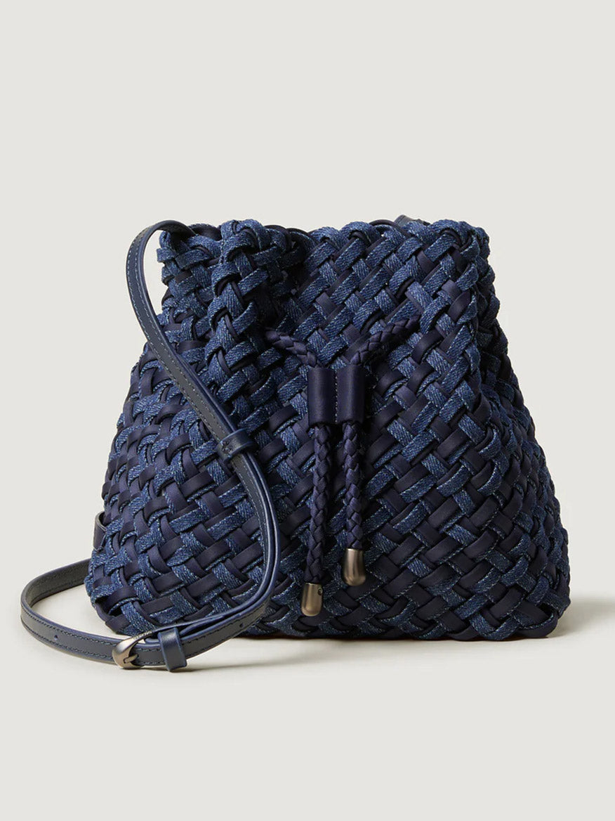 The Naghedi Gramercy Bucket Double Weave in Indigo features an adjustable crossbody strap and drawstring closure, showcased against a plain light background.