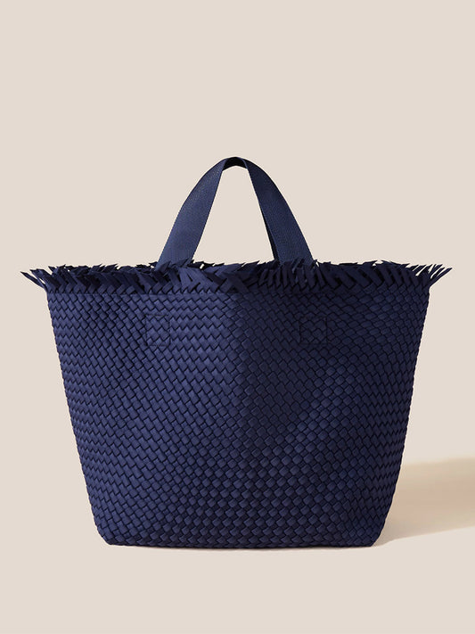 Naghedi Havana Beach Tote in Solid Ink Blue Fringe with fringe detail against a neutral background.