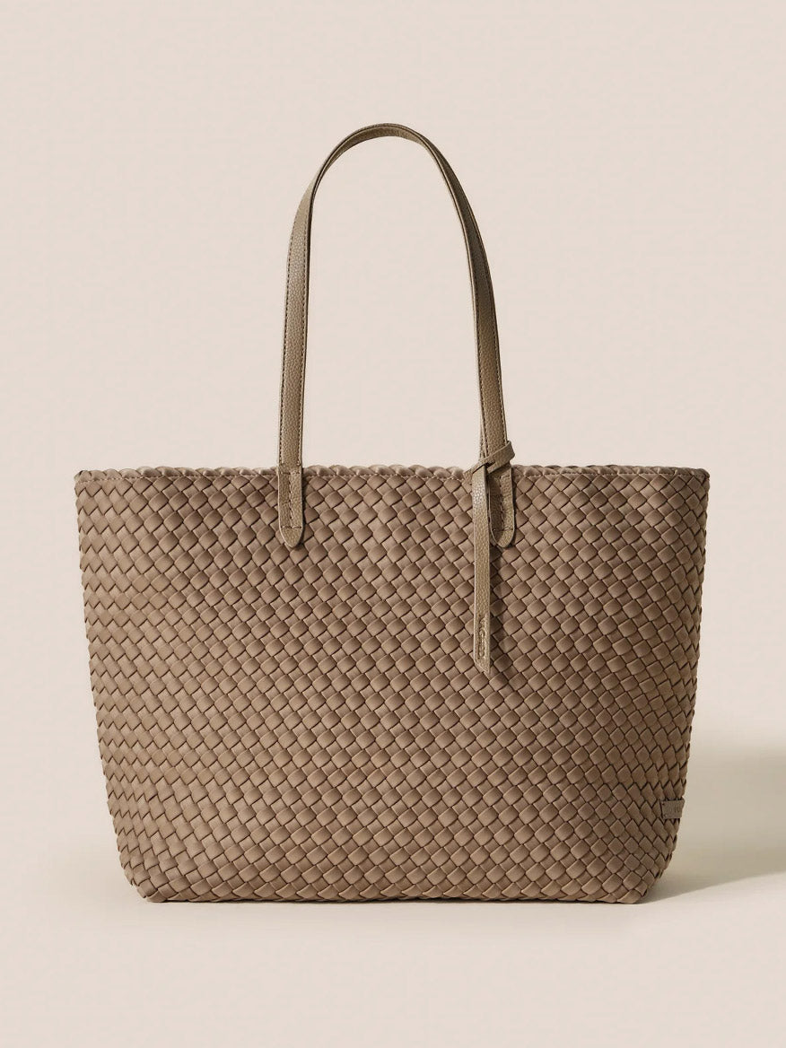 The Naghedi Jetsetter Small Tote in Solid Cashmere is a tan woven handbag crafted from handwoven neoprene, featuring two handles and displayed against a plain background.