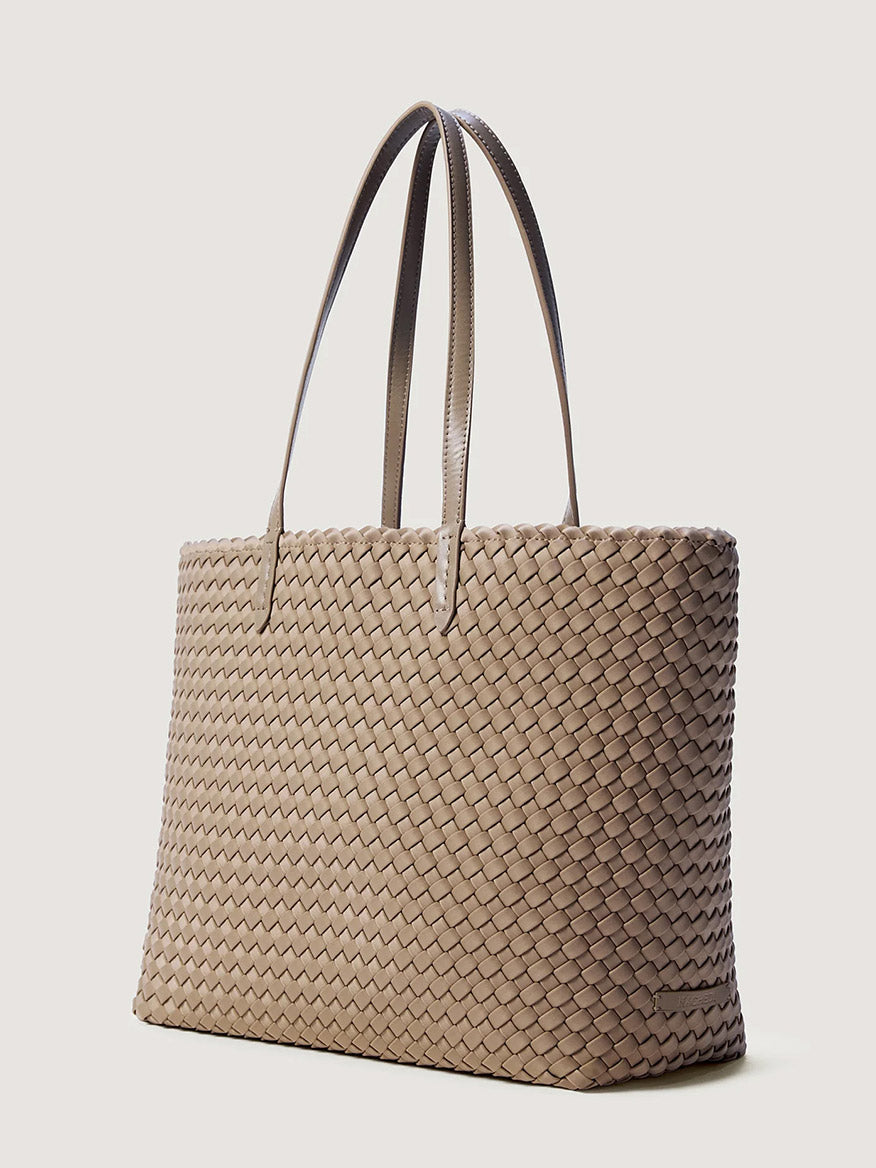 Naghedi Jetsetter Small Tote in Cashmere, a beige handwoven neoprene tote bag with two shoulder straps.