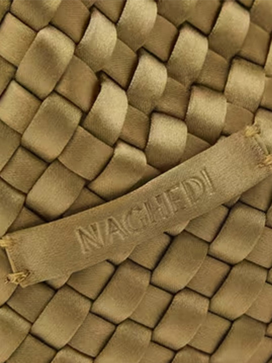 Close-up of a Naghedi Kyoto Clutch Satin in Peridot, featuring a woven textile and an embossed brand label.