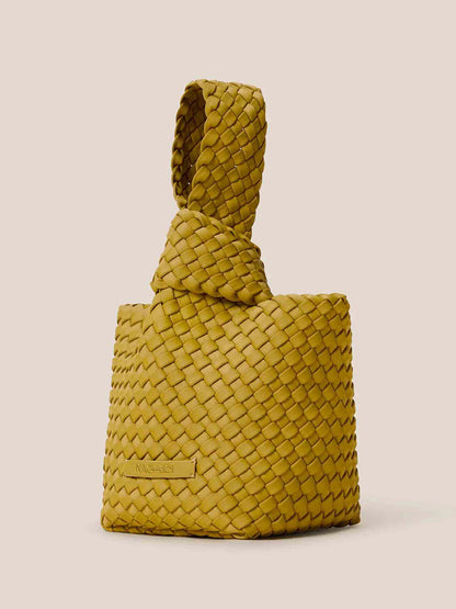 The Naghedi Kyoto Clutch in Solid Chartreuse is a yellow woven handbag featuring a stylish handwoven neoprene handle, perfect for complementing evening outfits with its chic beige background.