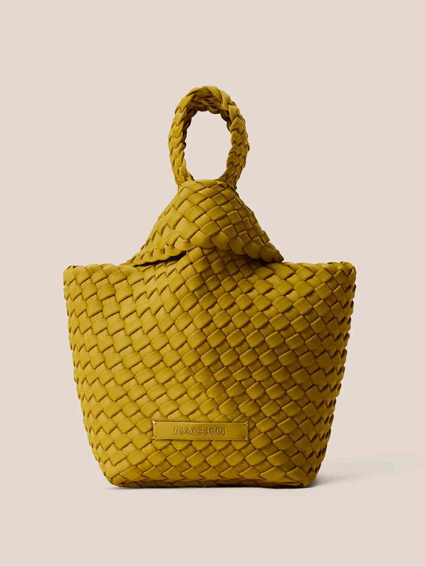 The Naghedi Kyoto Clutch in Solid Chartreuse, featuring a loop handle and woven design, adds a chic touch against a beige background, making it perfect for evening outfits.