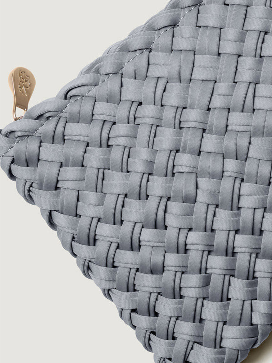 Close-up of a grey handwoven Naghedi Nomad Medium Hobo Double Weave in Marina featuring a zipper pull.