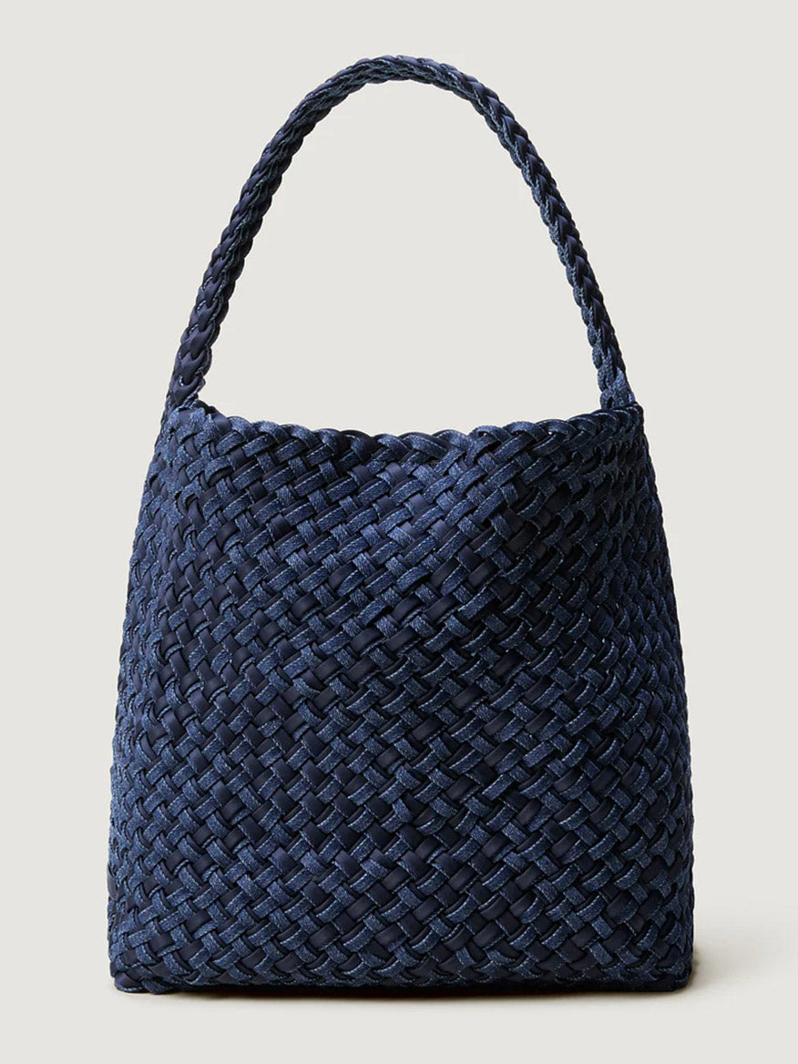 The Naghedi Nomad Medium Hobo Double Weave Denim in Indigo is a spacious, lightweight navy tote with a wide strap, shown standing upright against a plain light background.