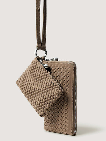 A light brown woven Naghedi Orly Phone Case in Cashmere and matching small pouch hanging from a strap.