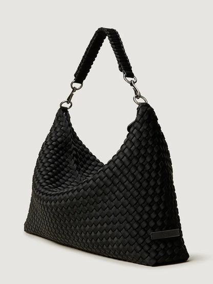 The Naghedi Porto Medium Half-Moon Bag in Onyx is a black handwoven leather hobo-style handbag with a short, sturdy handle, displayed against a plain background.
