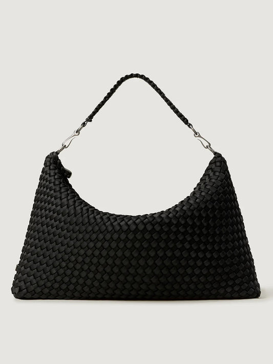 The Naghedi Porto Medium Half-Moon Bag in Onyx is a black handwoven shoulder bag with a short handle and silver hardware, shown against a plain light background.