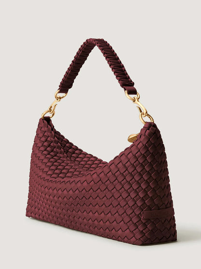 Naghedi Porto Small Half-Moon Bag in Bordeaux, a dark red handwoven shoulder bag with gold hardware.