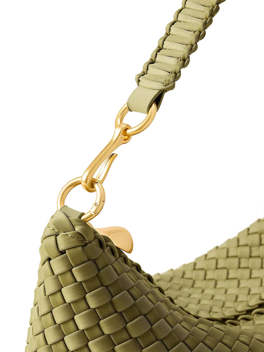 Close-up of a handwoven neoprene Naghedi Porto Small Half-Moon Bag in Bottle Green, featuring a braided strap and gold-tone hardware.