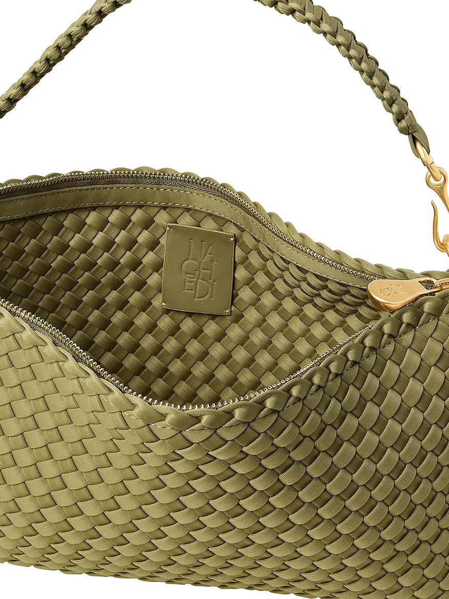 Close-up of a half-moon shaped Naghedi Porto Small Half-Moon Bag in Bottle Green, featuring a braided handle and an interior brand label.