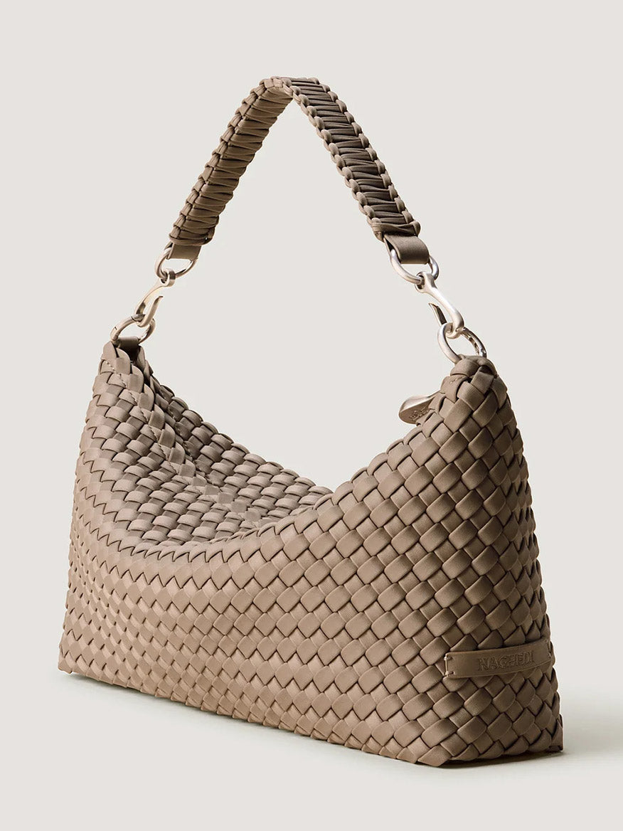 Taupe Naghedi Porto Small Half-Moon Bag in Cashmere with a handwoven neoprene exterior and a matching woven handle.