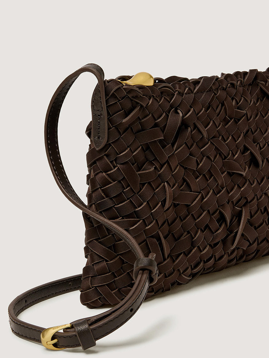 Chocolate Naghedi Soho Crossbody Nest Weave bag with a slim adjustable strap and gold-tone hardware.