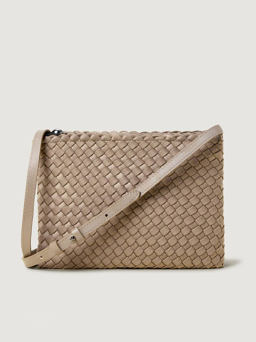 The Naghedi Soho Envelope Crossbody in Cashmere features tan woven neoprene and an adjustable leather strap, shown against a light background.