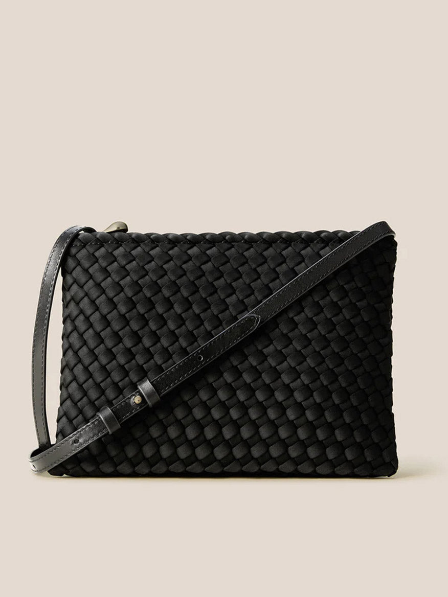 The Naghedi Soho Envelope Crossbody in Onyx is a black woven neoprene bag with a slim adjustable strap, displayed against a plain beige background.