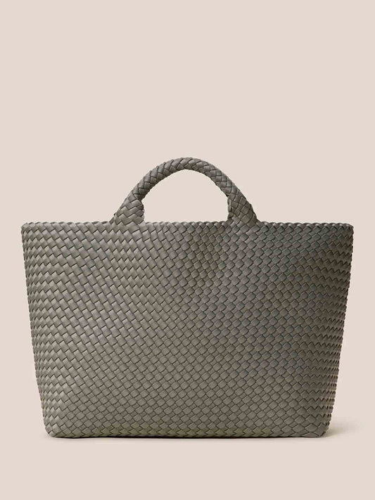 The Naghedi St. Barths Large Tote in Solid Laurel is a large laurel-colored tote crafted from handwoven material, featuring two short handles against a plain background.