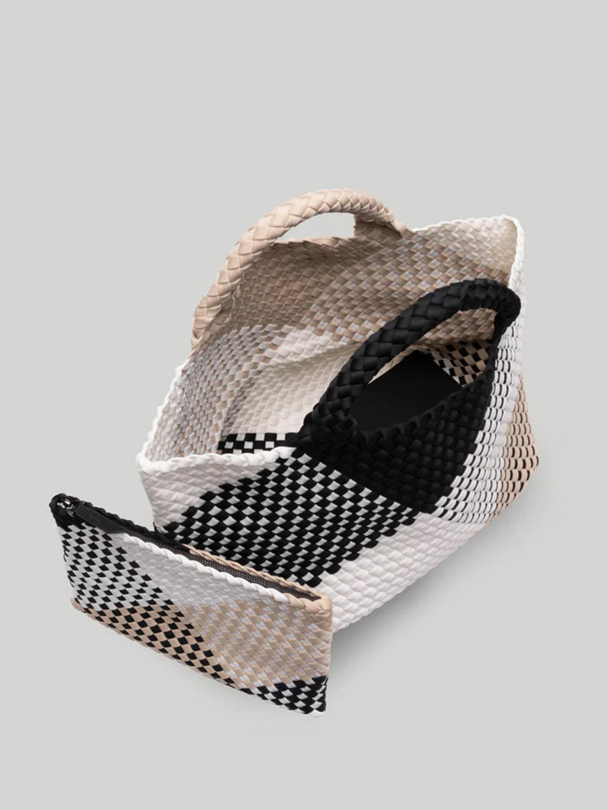 A black, white, and beige Naghedi St. Barths Medium Tote in Graphic Weave Palermo with a flat base and two handles, partially open to display the spacious interior.