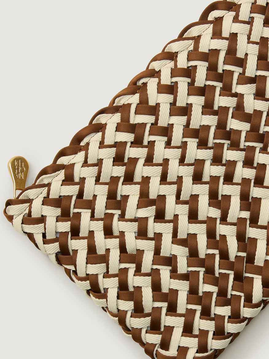 Close-up of the Naghedi St. Barths Medium Tote in Double Weave Carmel, showcasing its handwoven neoprene design in beige and brown with gold hardware and a small gold zipper pull on the left side.