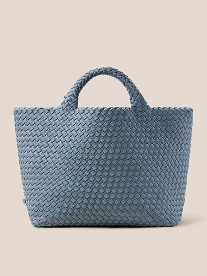 The Naghedi St. Barths Medium Tote in Solid Nova, crafted from handwoven neoprene, showcases a striking large blue design with two sturdy handles against a beige background—making it the perfect everyday bag.