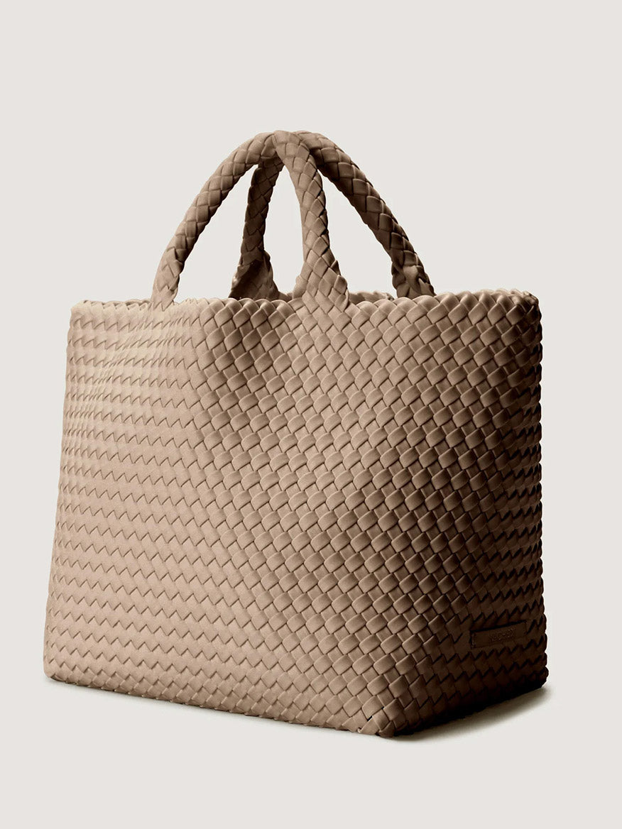 Naghedi St. Barths Medium Tote in Cashmere, a beige handwoven tote bag with two top handles.