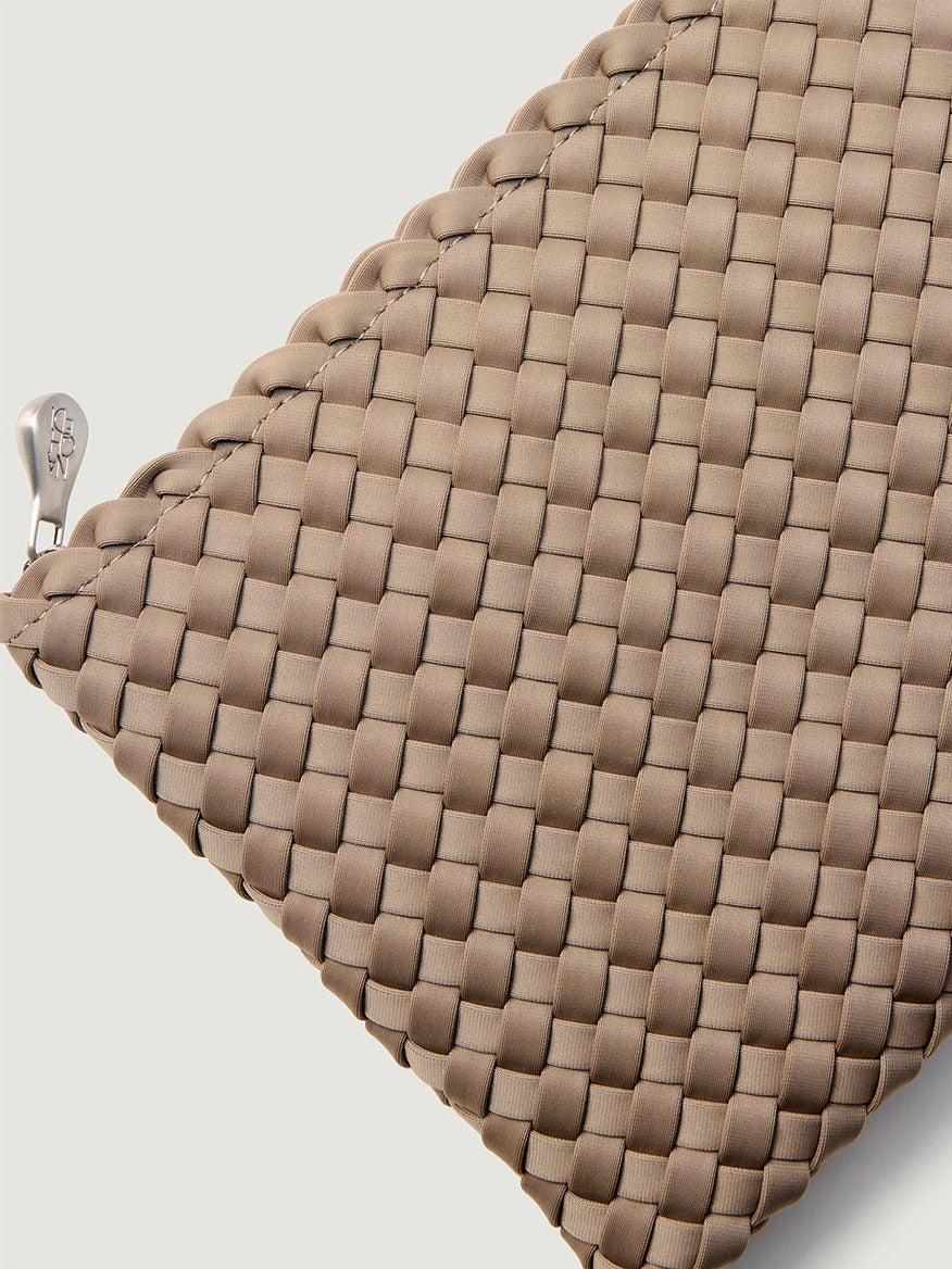 Naghedi St. Barths Medium Tote in Cashmere, a taupe handwoven everyday bag with a silver zipper pull.