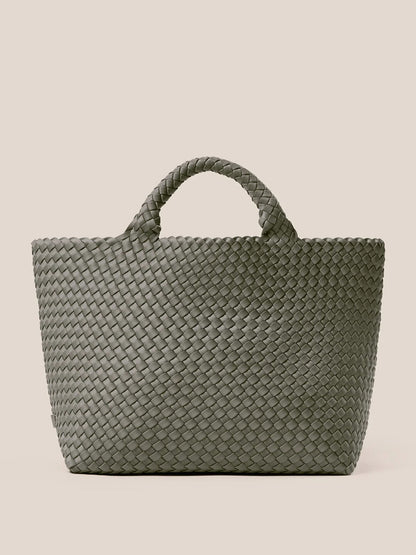 The Naghedi St. Barths Medium Tote in Solid Laurel is a versatile everyday bag crafted from handwoven neoprene, featuring a large green design with two sturdy handles set against a beige background.