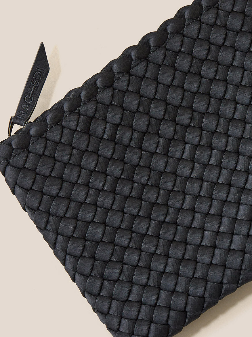 Close-up of a Naghedi St. Barths Small Tote in Graphic Ombre Basalt with a visible brand tag.