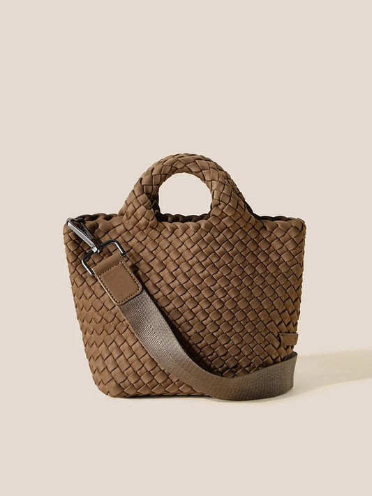 A Naghedi St. Barths Petit Tote in Solid Mink, featuring a small handwoven neoprene design with a short handle and an adjustable crossbody strap, displayed on a neutral background.