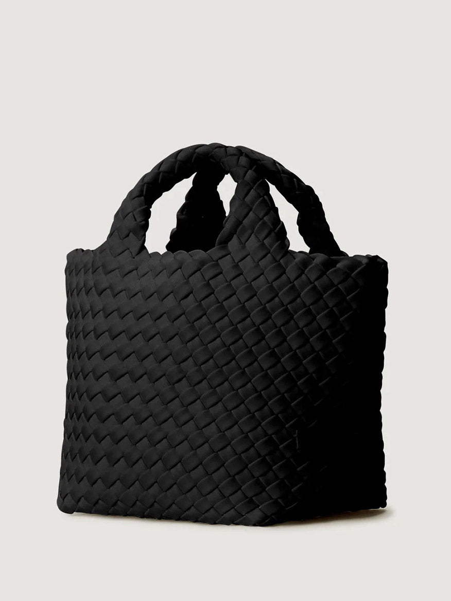 Naghedi St. Barths Petit Tote in Onyx, a small black handwoven neoprene tote bag with two top handles and a crossbody strap.