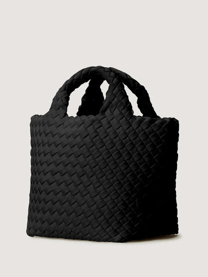 Naghedi St. Barths Petit Tote in Onyx, a small black handwoven neoprene tote bag with two top handles and a crossbody strap.