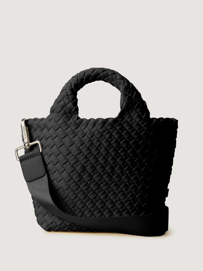 Naghedi St. Barths Petit Tote in Onyx: a small handwoven neoprene tote bag in black with rounded top handles and a detachable crossbody strap.