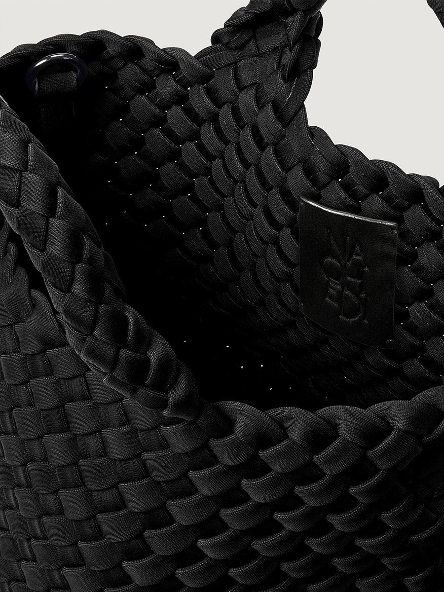 Naghedi St. Barths Petit Tote in Onyx, a handwoven neoprene mini tote bag in black featuring a small interior brand tag.