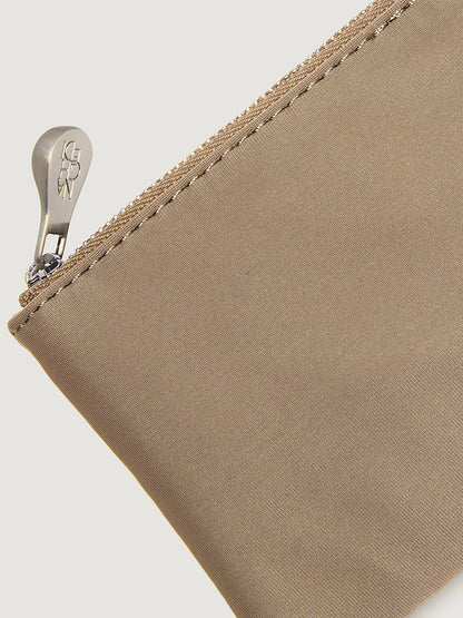 Close-up of a tan Naghedi St. Barths Petit Tote Nest Weave in Cashmere zippered pouch with a metallic pull.