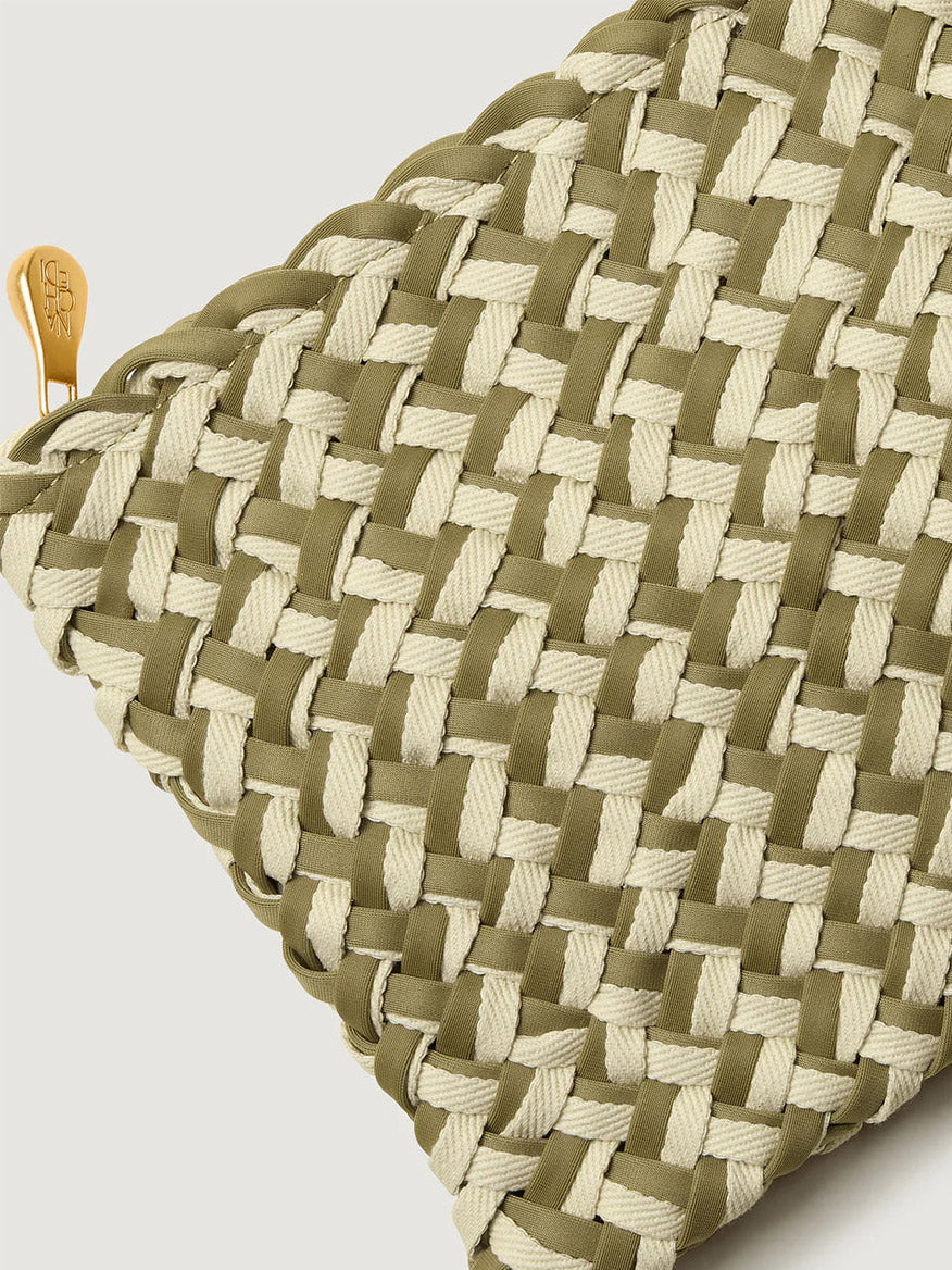 Close-up of a Naghedi St. Barths Small Tote Double Weave in Oletta, featuring an olive green and cream grid pattern with a gold zipper pull.