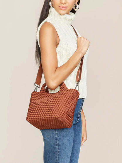 Woman posing with a Naghedi St. Barths Small Tote in Solid Adobe.