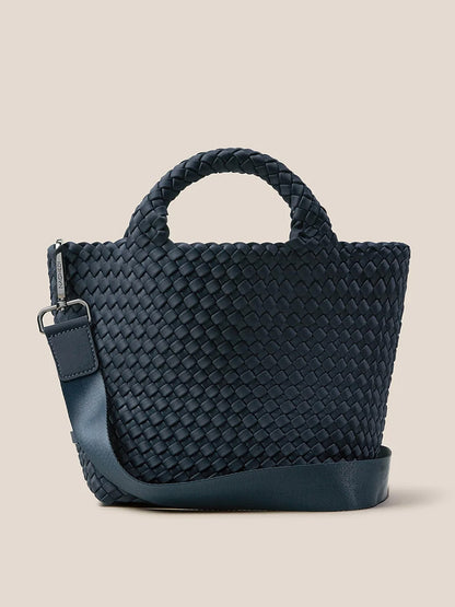 The Naghedi St. Barths Small Tote in Solid Murano is crafted from handwoven neoprene and features short handles along with a detachable crossbody strap, set against a neutral background.