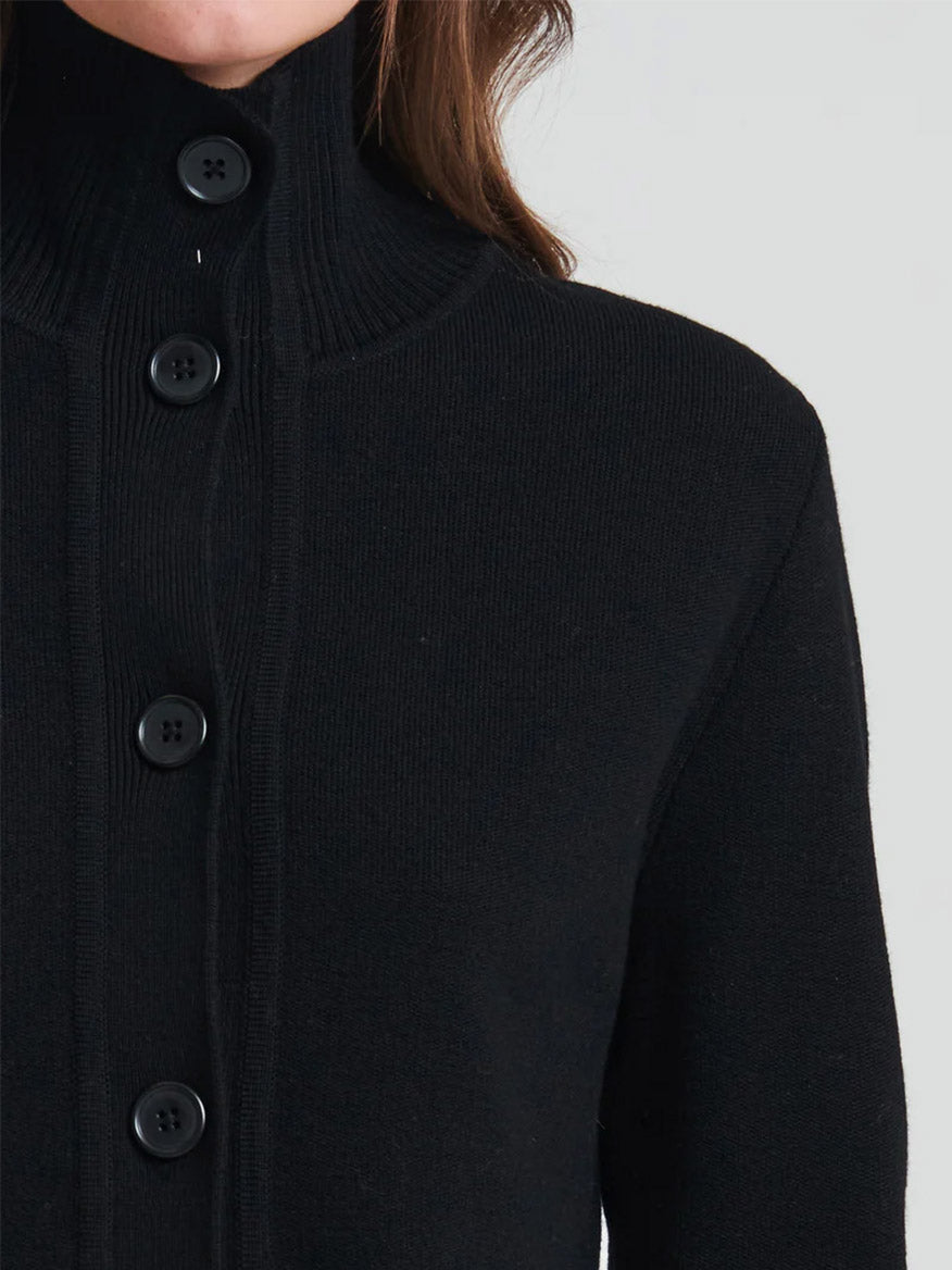 Close-up of a person wearing a black Patrick Assaraf Merino Button Front Milano Jacket.