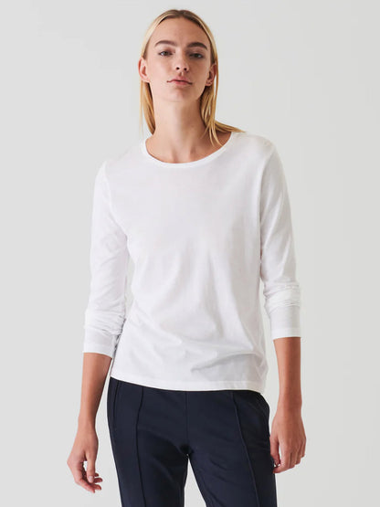 A woman in a luxuriously soft Patrick Assaraf Lightweight Pima Cotton T-Shirt, available in white.