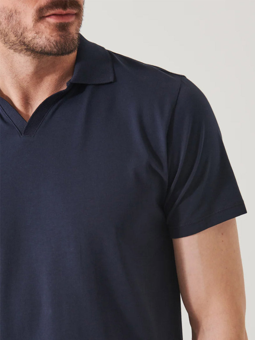 Close-up of a man wearing a Patrick Assaraf Pima Cotton Stretch Open Polo in Midnight, focusing on the shirt and neckline, with the lower part of his face visible.