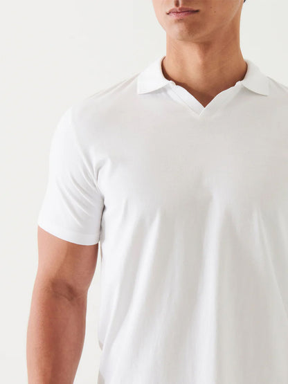 Close-up of a man wearing a Patrick Assaraf Pima Cotton Stretch Open Polo in White, focusing on the short sleeve and collar with a white background.