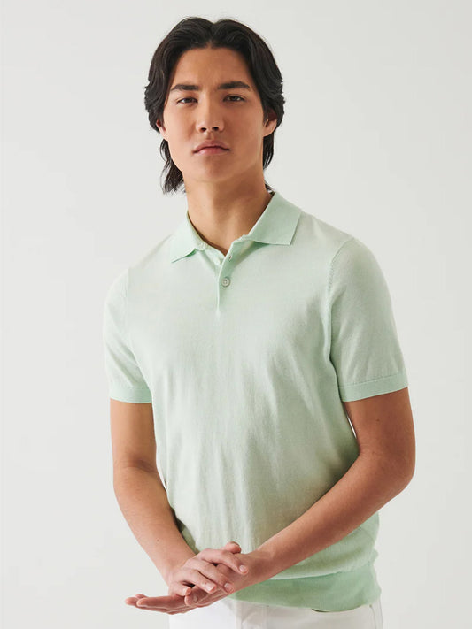 Young Asian man in a Patrick Assaraf Cotton Cupro Polo in Lime standing against a white background, looking calmly at the camera.