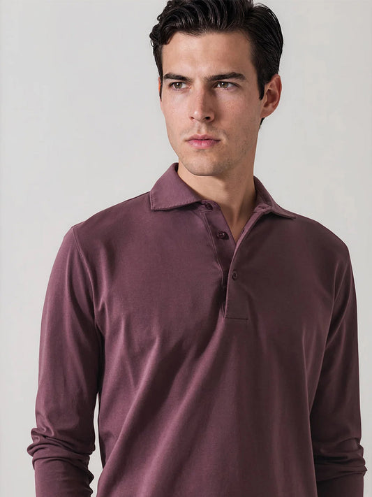 A man with dark hair wears the Patrick Assaraf Pima Cotton Stretch Long Sleeve Polo in Prune and looks slightly to the side against a plain light background.