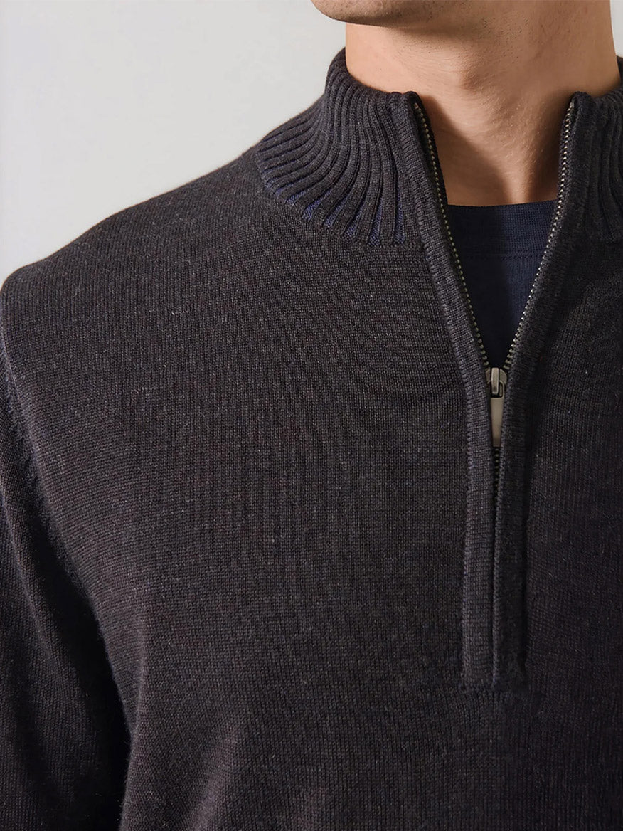Close-up of a person wearing the Patrick Assaraf Merino Plaited Quarter Zip in Brownie, featuring a ribbed collar detail and partially unzipped to show a dark shirt underneath. The refined silhouette provides lightweight warmth, making it ideal for layering in any season.