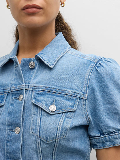 Close-up of a woman wearing a Paige Kendra Puff Short Sleeve Jacket in Lowen with silver buttons, focusing on the collar and chest pockets.