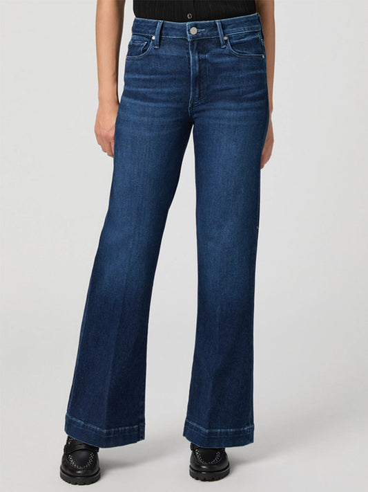 Wearing the Paige Leenah Petite Wide Leg Jean in Praline and black shoes, this look stands out against a light background—an easy, chic way to highlight petite denim style.