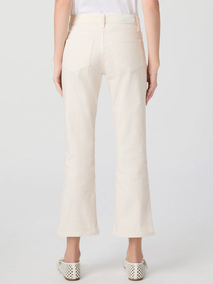Person wearing Paige Mason Crop Bootcut Jean in Tonal Stripe, paired with a white top and white perforated shoes, shown from the back against a plain background.