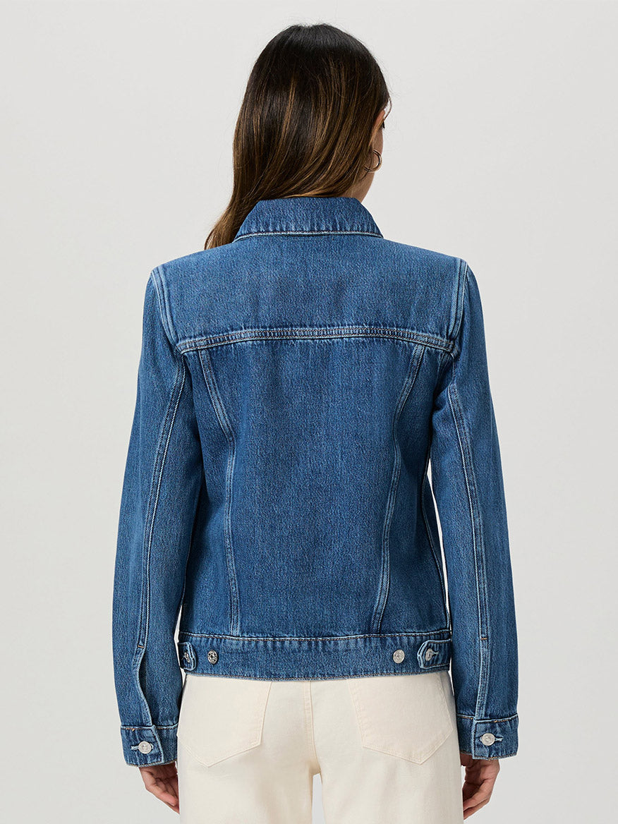 A person with long brown hair wearing the Paige Rowan Jacket in Bellisimo and white pants, shown from the back against a plain light background.